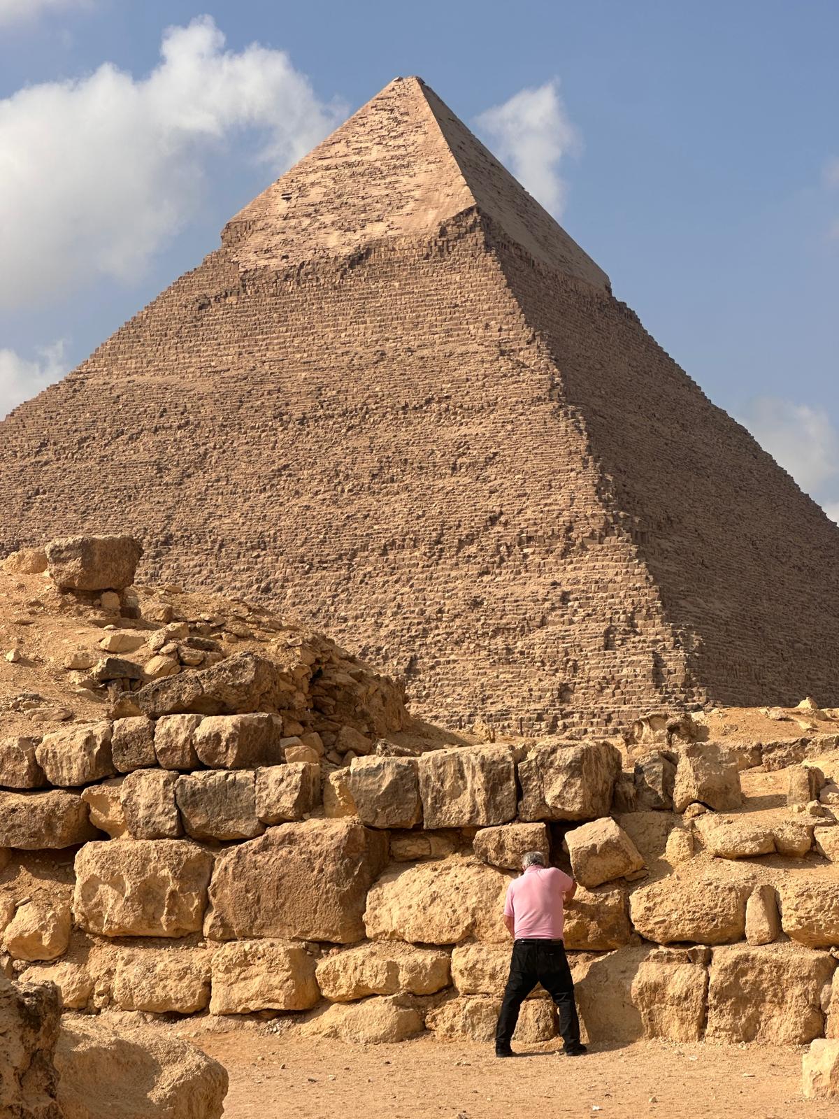 Traveler standing before the Great Pyramid on the Giza Plateau