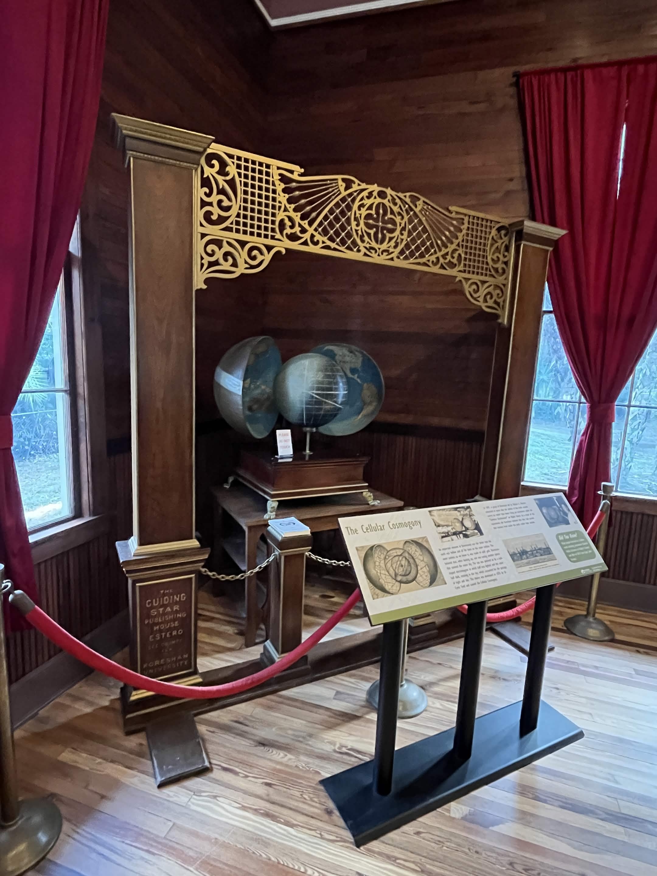 Koreshan orrery at the Guiding Star Publishing House, Estero, Florida — the concave earth model behind red velvet ropes