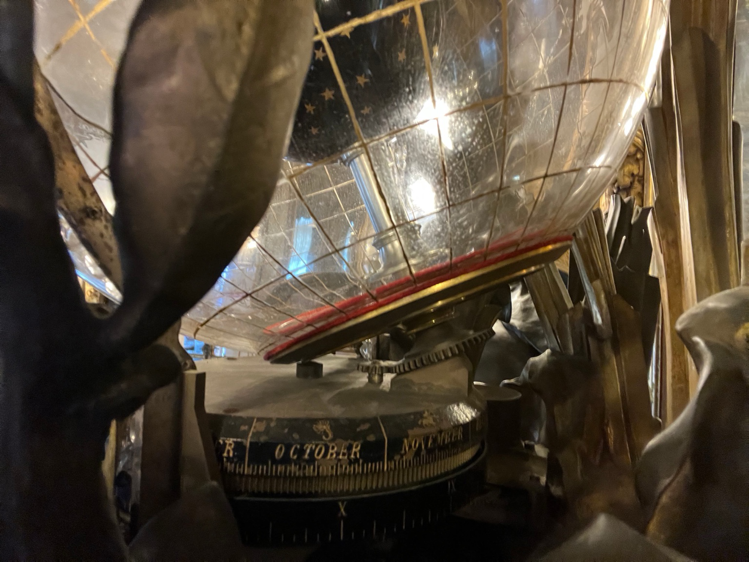 Underside view showing the lower calendar ring, support structure, and the globe seated above the mechanism