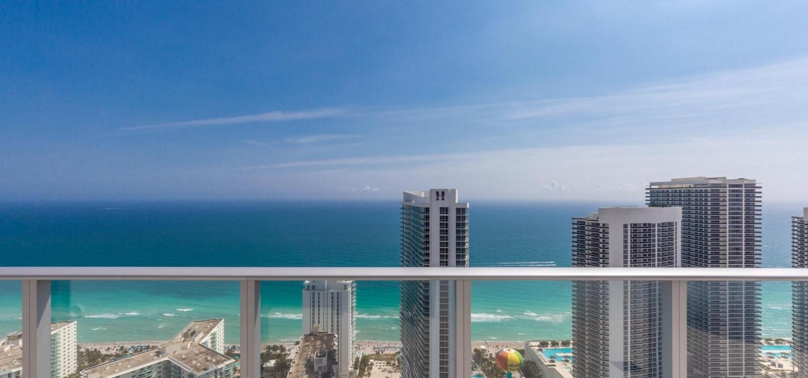 High-rise condo view over a distant beachfront horizon